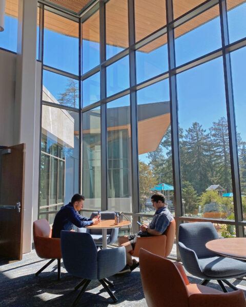 Two men sitting in front of window at the new Burlingame Community Center